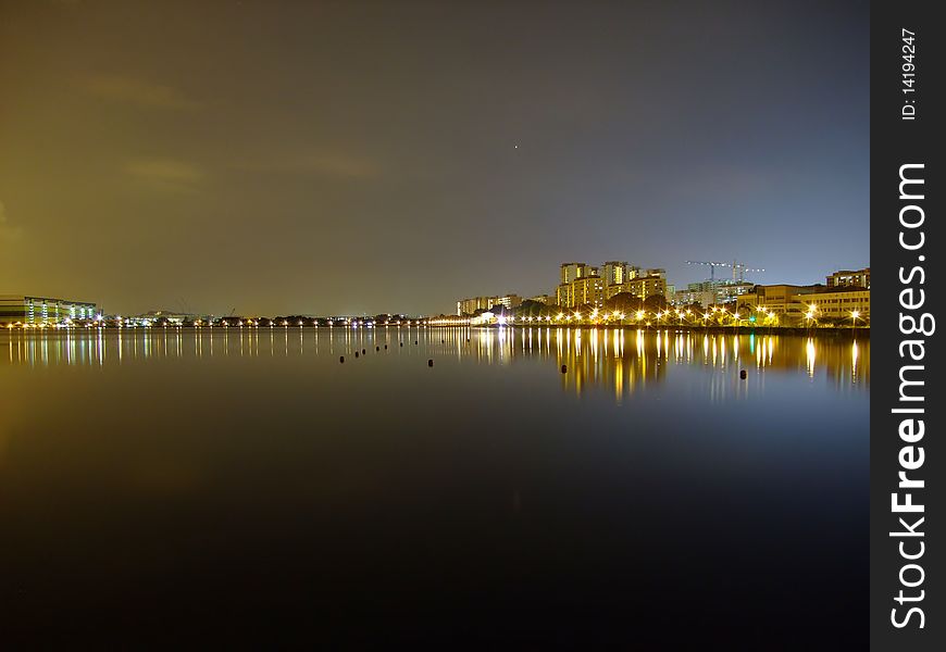 Pandan Reservoir with blue night sky at the right and yellowish one at the left. Pandan Reservoir with blue night sky at the right and yellowish one at the left