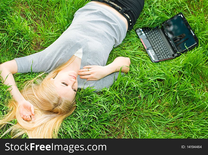 Series. The beautiful business woman with the laptop has a rest in the field