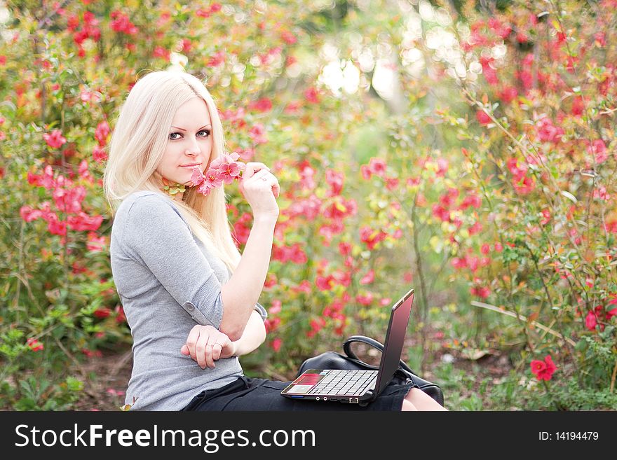 Series. The beautiful business woman with the laptop has a rest in the field