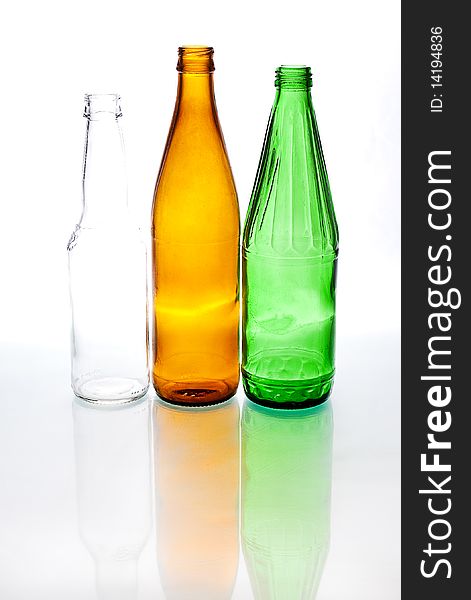 Three colored bottles with reflection