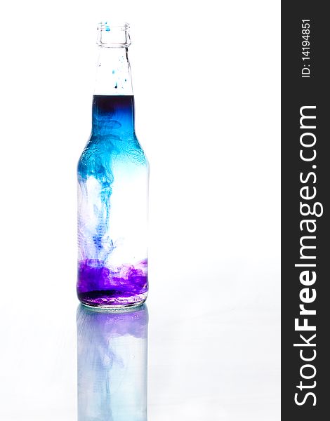 Blue and purple water, bottle with reflection. Blue and purple water, bottle with reflection