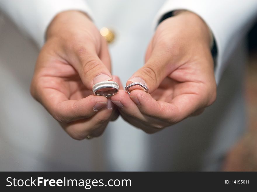 Man is Holding Wedding rings in the hands