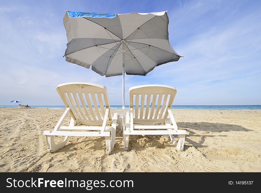 Two chairs under blue sky in tropical cuban beach, Santa Maria, cuba. Two chairs under blue sky in tropical cuban beach, Santa Maria, cuba.