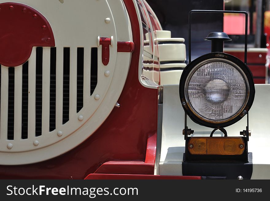 A head light of a small train in red and white color, which in wonderful shape and line. A head light of a small train in red and white color, which in wonderful shape and line.
