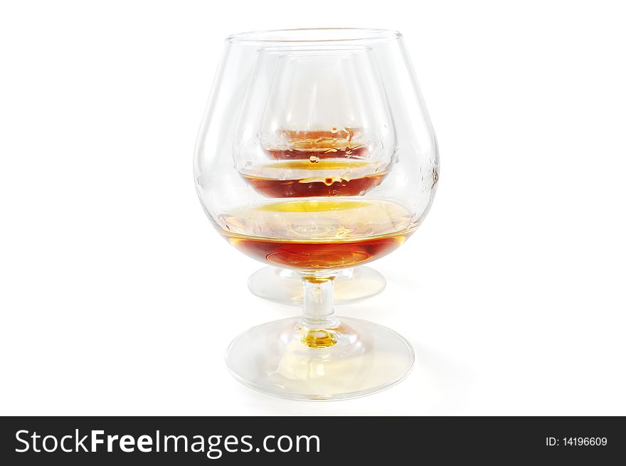 Glasses of cognac ranked isolated on a white background. Glasses of cognac ranked isolated on a white background