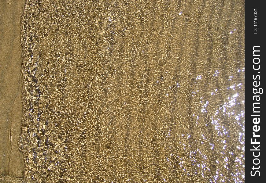Edge of the waterline on a sand beach. Edge of the waterline on a sand beach