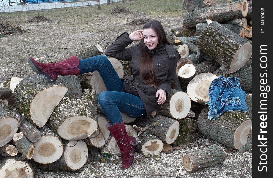 Young beautiful girl lying on logs