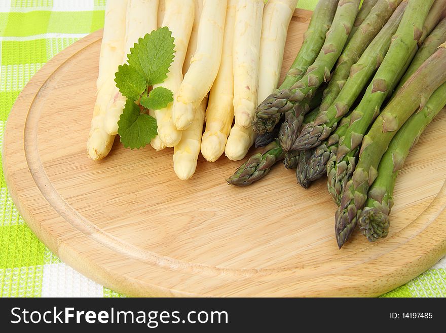White and green asparagus on table