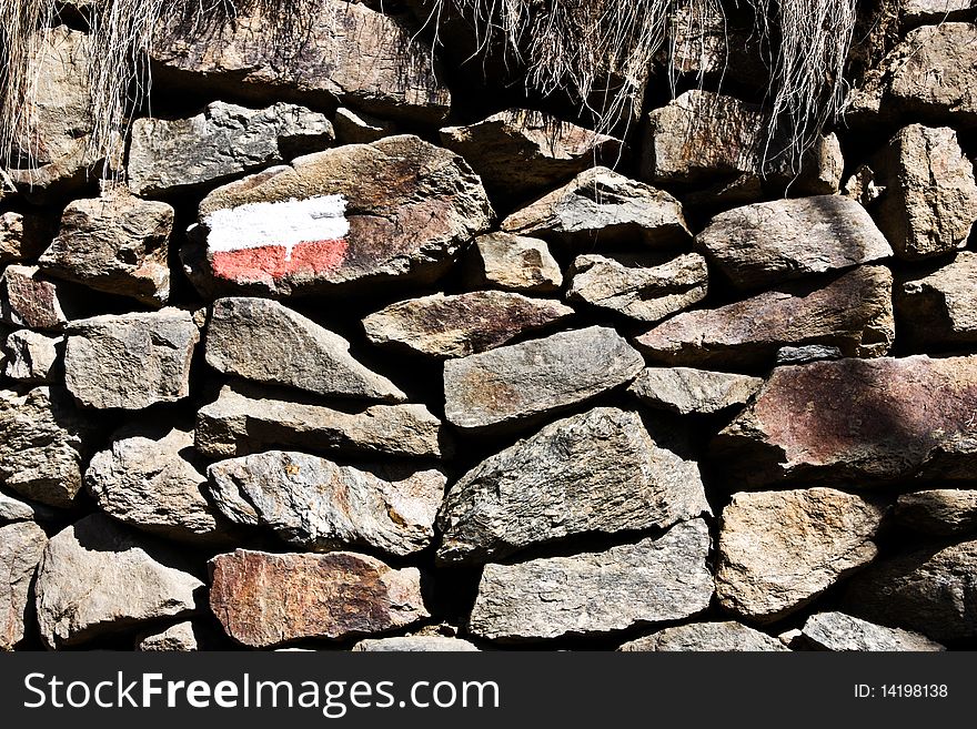 Stonewall with the sign of the mountain path, good for conceptual. Stonewall with the sign of the mountain path, good for conceptual