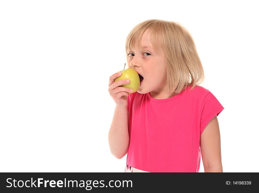 Young little girl eating an apple