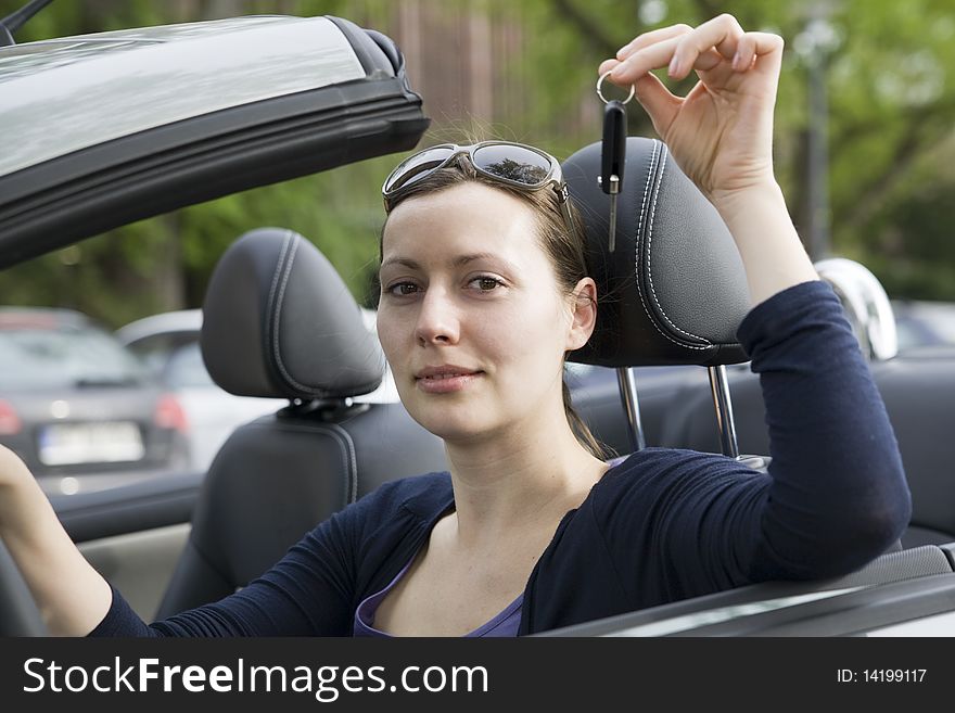 Young woman with keys in a cabriolet. Young woman with keys in a cabriolet