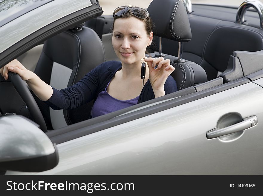 Young woman with keys in a cabriolet. Young woman with keys in a cabriolet