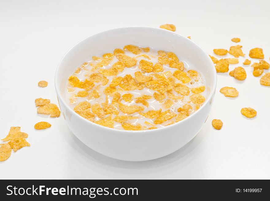 Bowl with milk and corn flakes. Bowl with milk and corn flakes