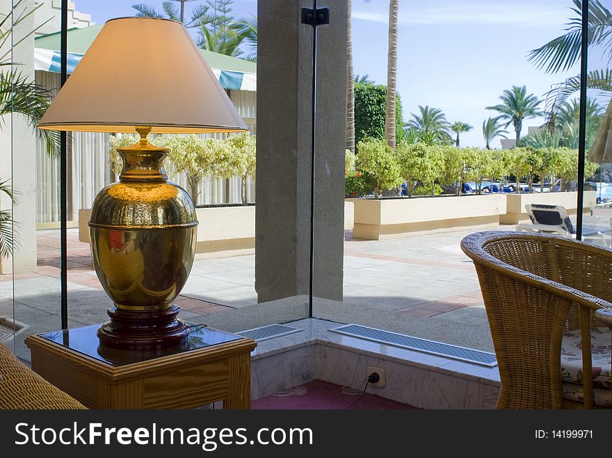 Table lamp chair window plants palm trees. Table lamp chair window plants palm trees