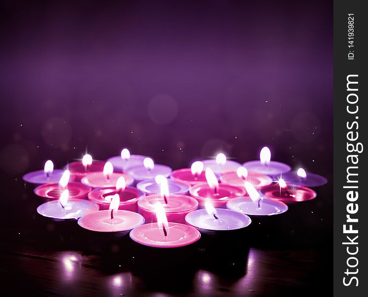 Background with heart set of candles in pink and purple color. Background with heart set of candles in pink and purple color