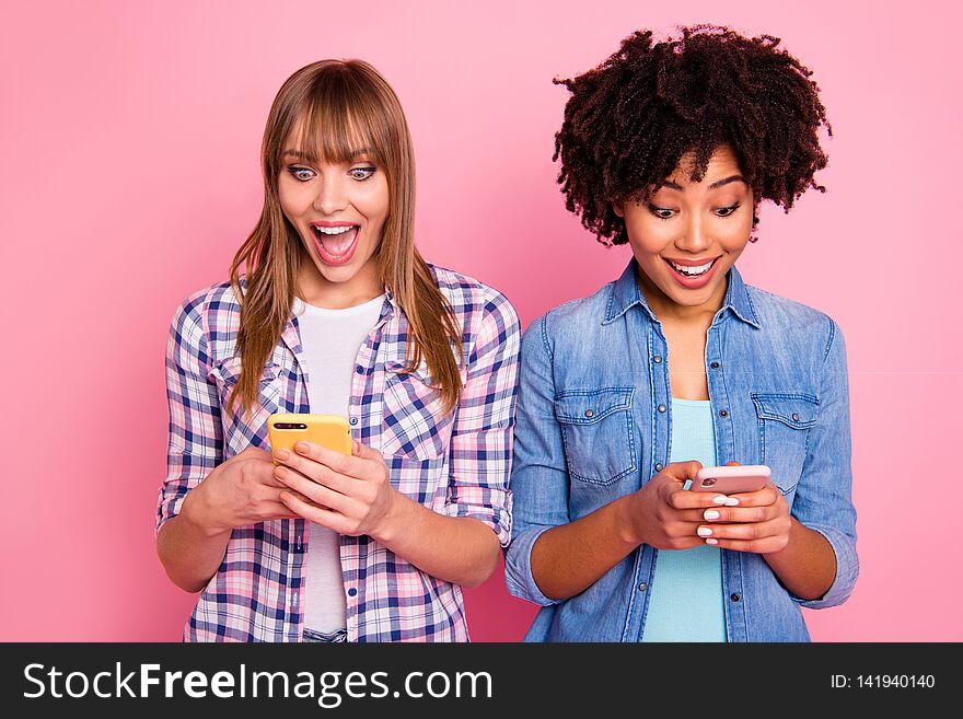 Portrait of her she two person nice-looking cute attractive charming cheerful girls wearing casual using device gadget app 5g wi-fi connection over pink pastel background.