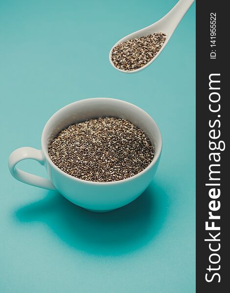 Cup of healthy chia seeds and spoon. Text space