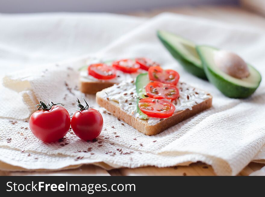 healthy and wholesome food. Namely, these are toasts with avocado and cherry tomatoes