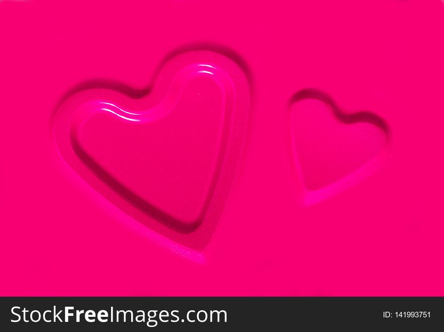 Two convex contours of hearts on a pink metallic background