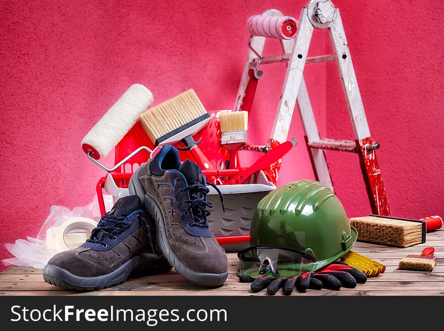 Safety equipment. Work shoes, gloves, helmet and goggles on an aged wooden table. Construction industry. Building. Safety equipment. Work shoes, gloves, helmet and goggles on an aged wooden table. Construction industry. Building