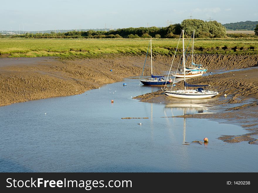 Yachts moored in a muddy inlet. Yachts moored in a muddy inlet