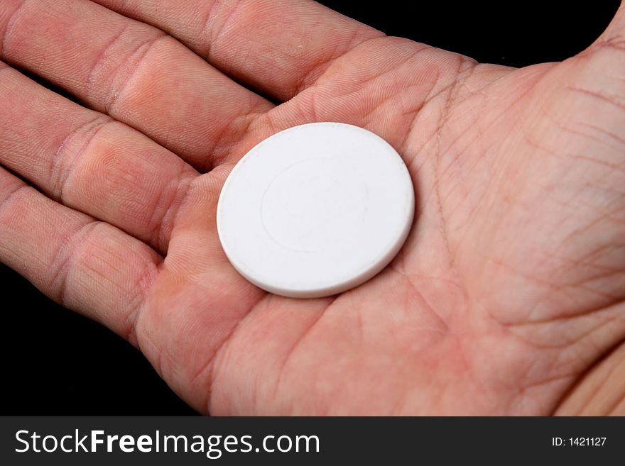 White coin in a man hand. White coin in a man hand