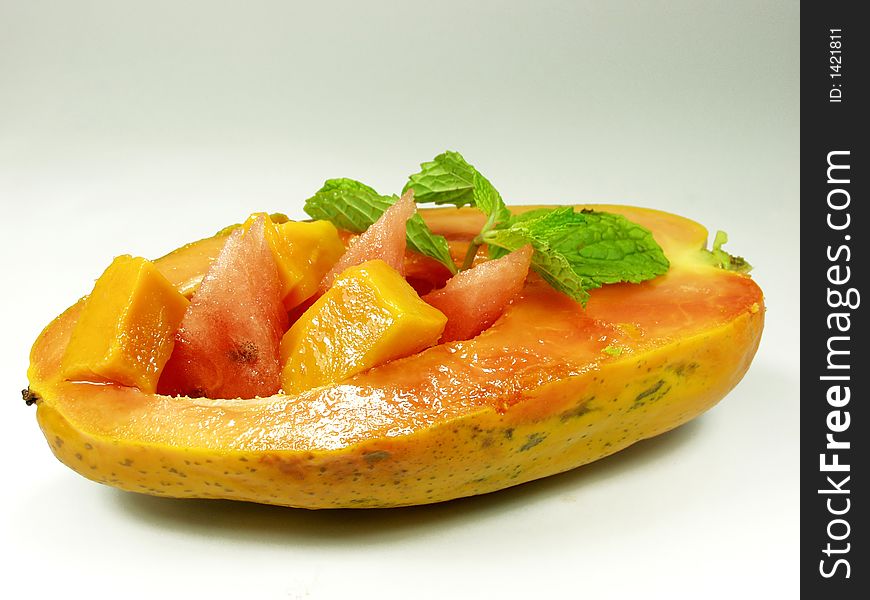 Half papaya fruit whit mango and watermelon and mint