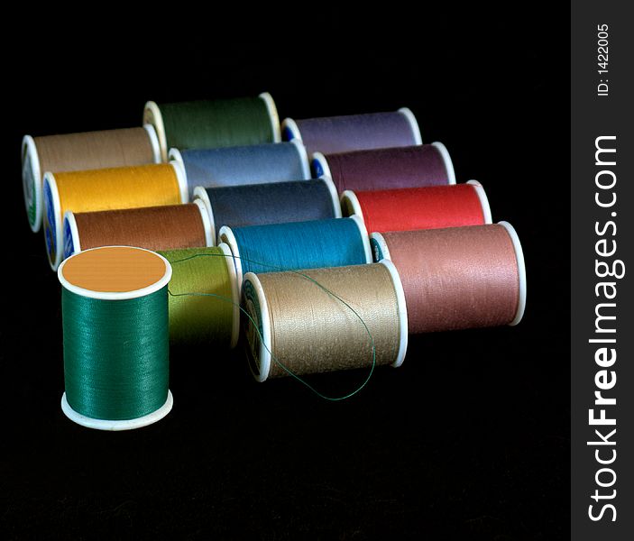 Spools of thread isolated on a black background