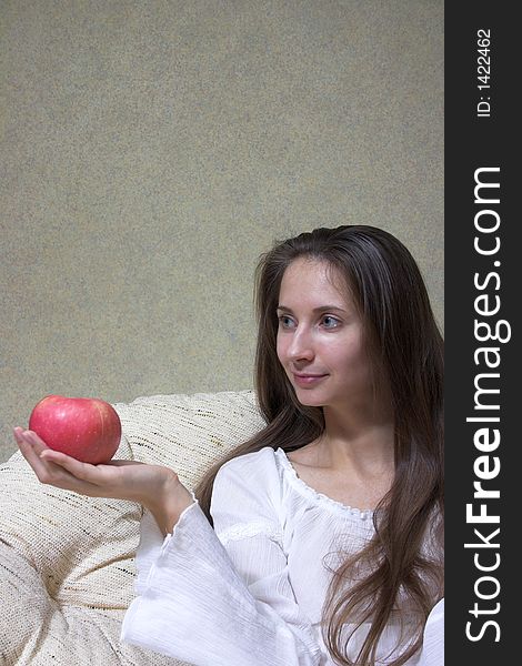 Pretty smiling woman with red apple. Portrait.