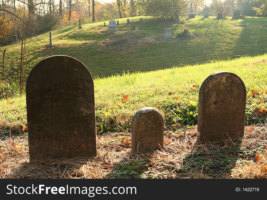 Three grave stones backlighted on a hill. Three grave stones backlighted on a hill