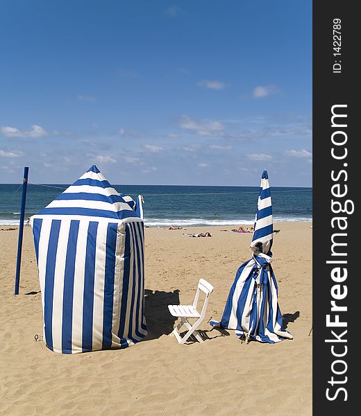 Striped blue and white beachtents on sand. Striped blue and white beachtents on sand