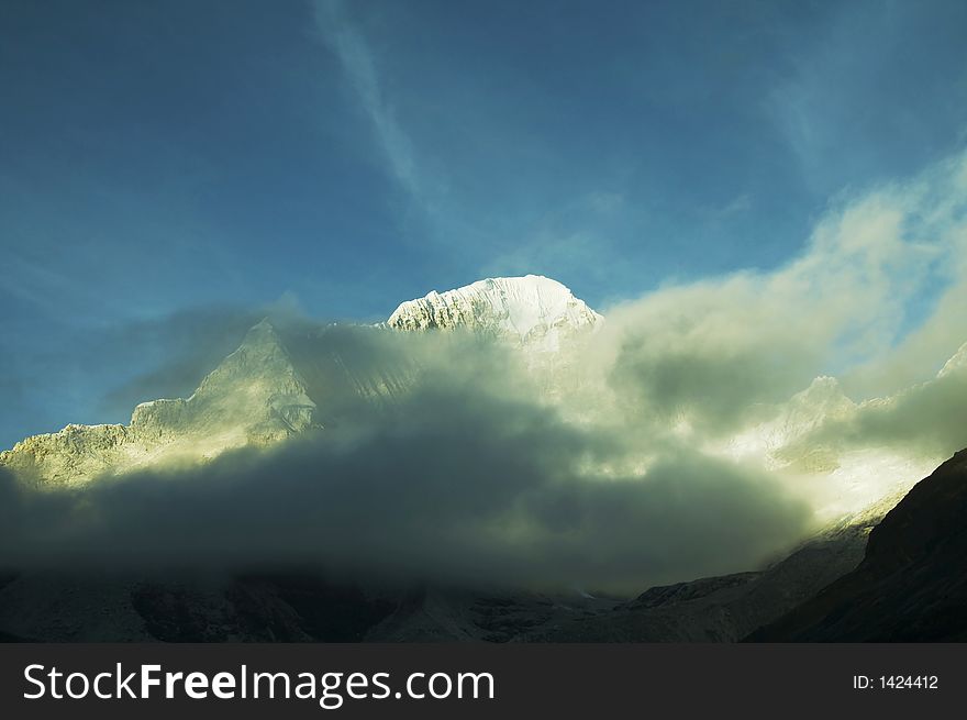 Snowcowered high cordillera mountain and mist. Snowcowered high cordillera mountain and mist