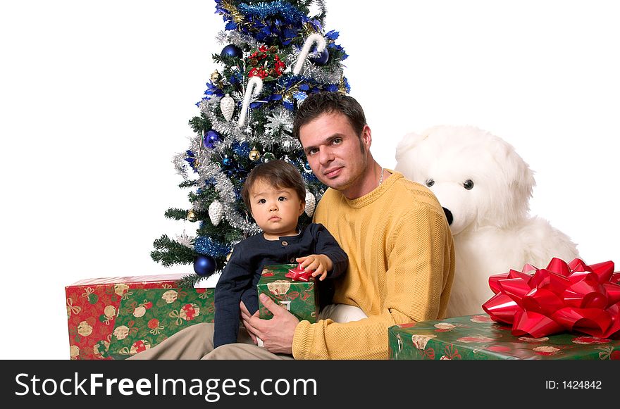 Father and son under the christmas tree, opening presents. Father and son under the christmas tree, opening presents