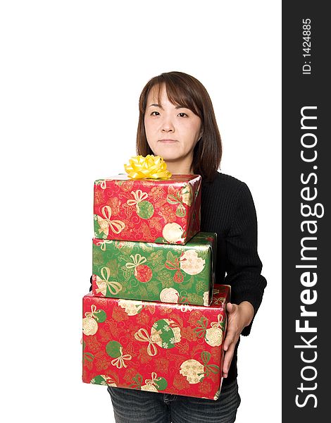 A young asian girl carrying  stack of christmas presents. A young asian girl carrying  stack of christmas presents