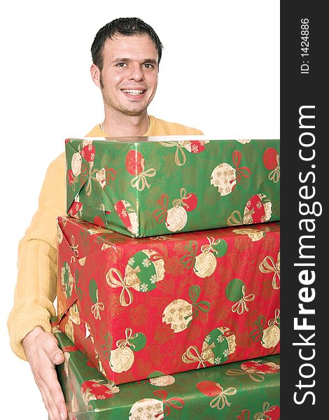 A young handsome guy carrying a  stack of christmas presents. A young handsome guy carrying a  stack of christmas presents