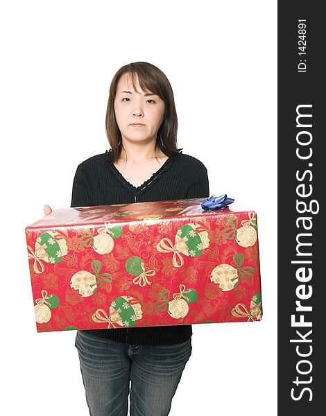 A young asian girl carrying a christmas present. A young asian girl carrying a christmas present