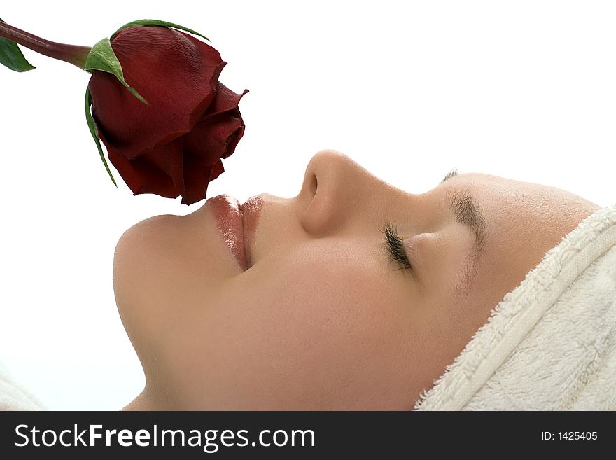 Beauty girl in towel with rose relaxing after shower on white background. Beauty girl in towel with rose relaxing after shower on white background