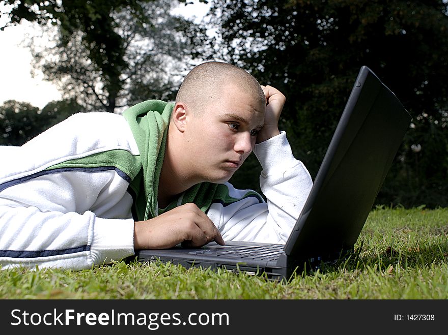 Boy With Notebook In Park