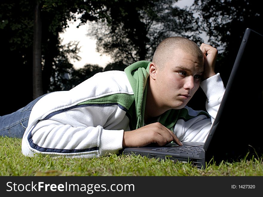 Boy with notebook in park