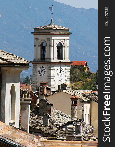 A clock tower that could be seen over all roofs of an Italian village.