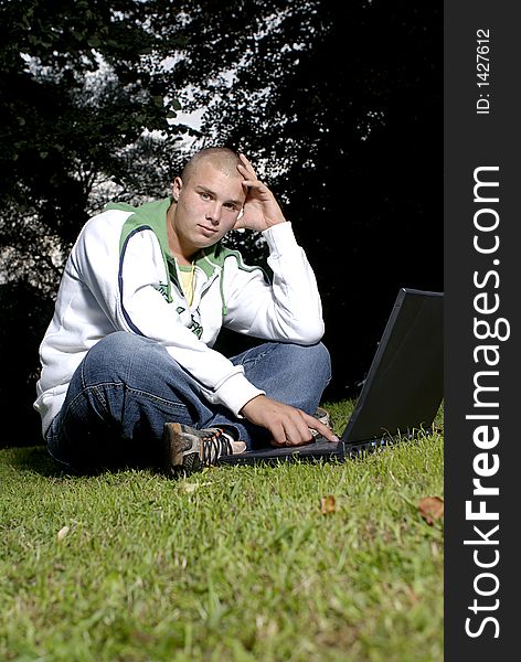 Boy With Notebook In Park