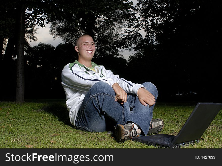 Boy with notebook in park