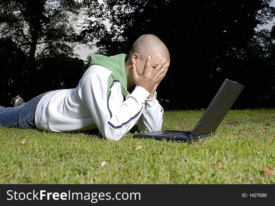 Boy With Notebook In Park