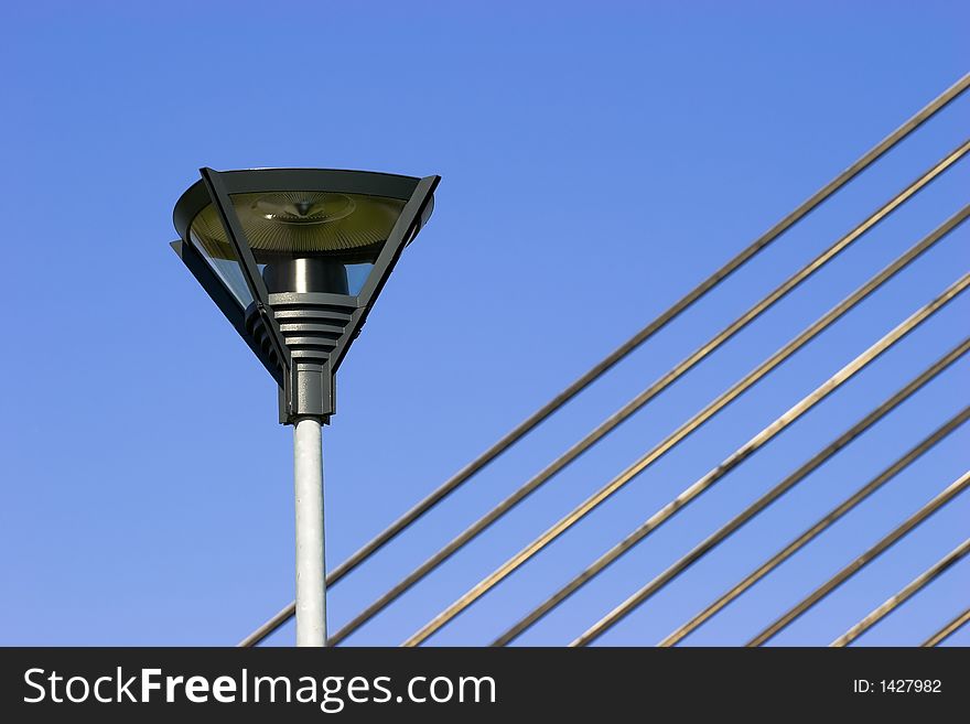 Lamppost and fragment of suspension bridge cables. Lamppost and fragment of suspension bridge cables