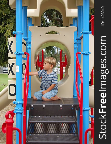 Boy playing tic-tac-toe on play equipment at a park. Boy playing tic-tac-toe on play equipment at a park.