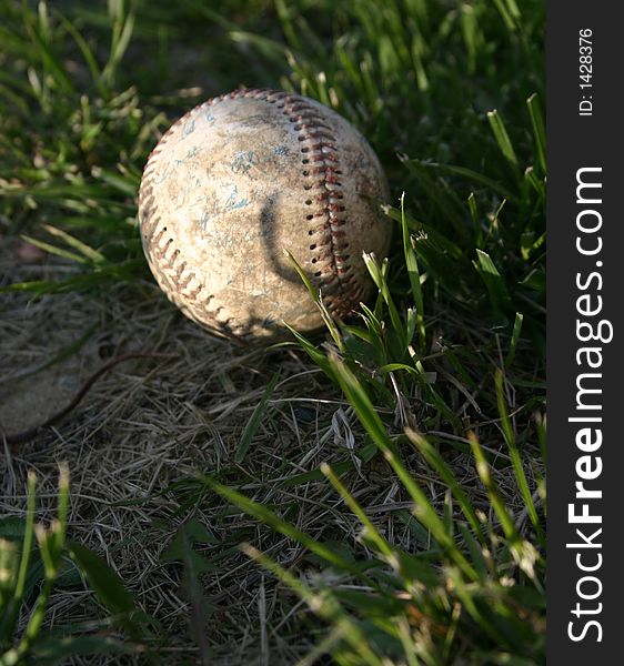 Old baseball ball in grass. Old baseball ball in grass