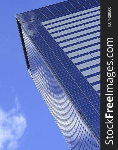 Skyscraper and cloudy sky windows reflections