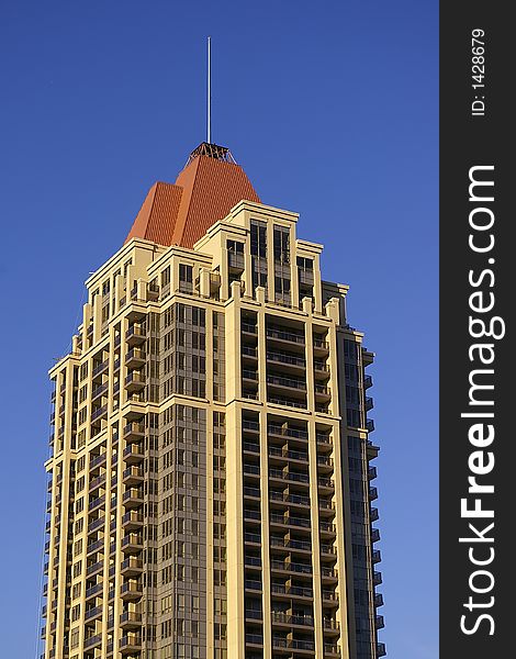 A modern highrise residential condominium building in an urban setting. A modern highrise residential condominium building in an urban setting