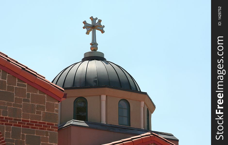 A small dome atop a Greek Orthodox church. A small dome atop a Greek Orthodox church.