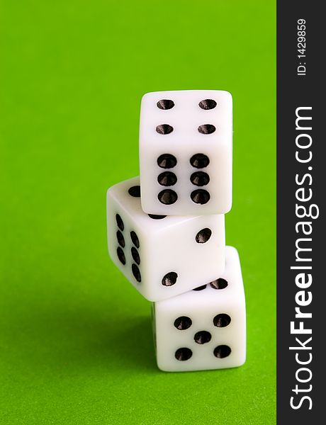 Three dices on a green background